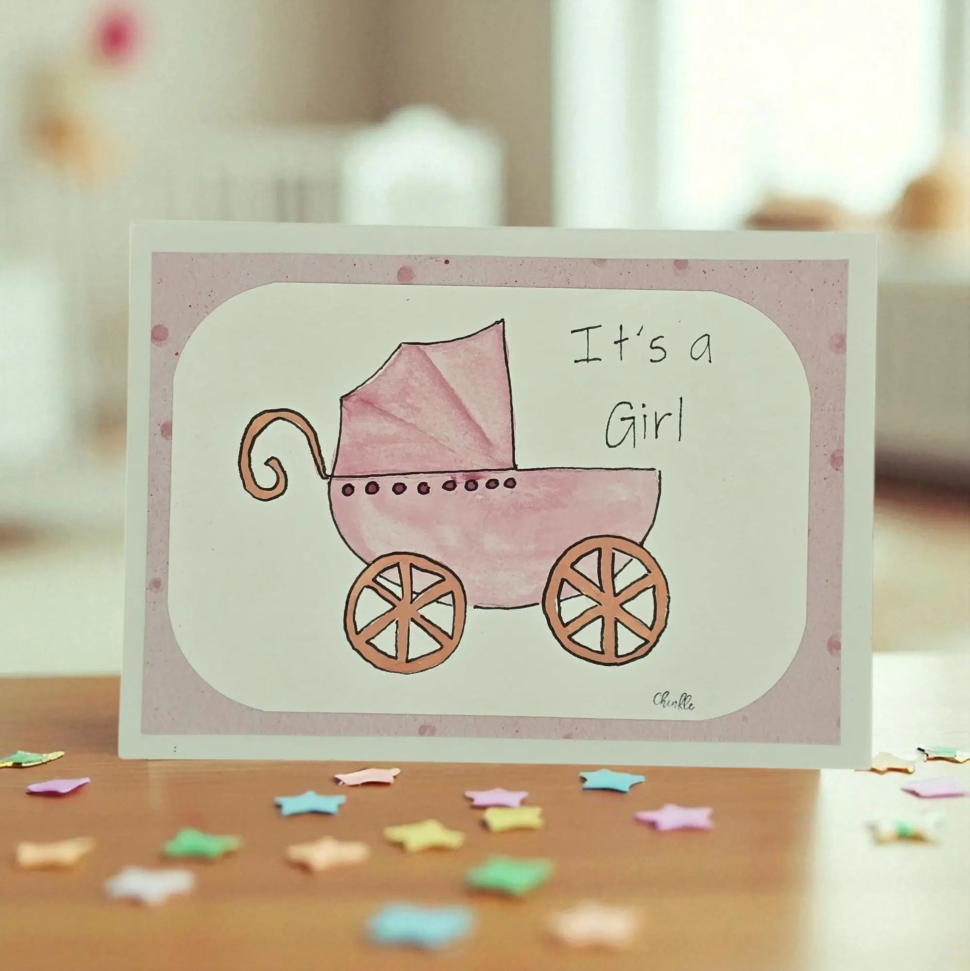 BABY GIRL GREETING CARD WITH A PINK CARRIAGE AND SAYING SAYS ITS A GIRL
