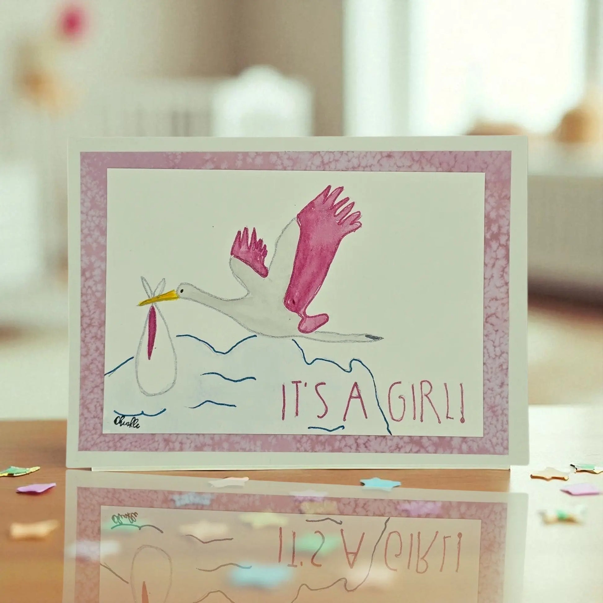 BABY GIRL GREETING CAR WITH A PINK STORK AND WORDS WRITTEN ITS A GIRL