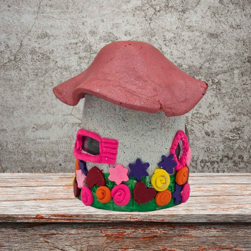 a cottage design fairy house night light with pink roof side view