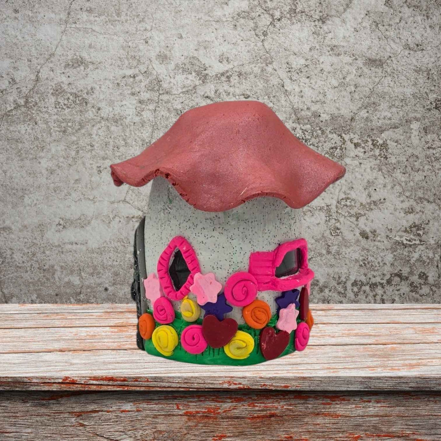 a cottage design fairy house night light with pink roof side view