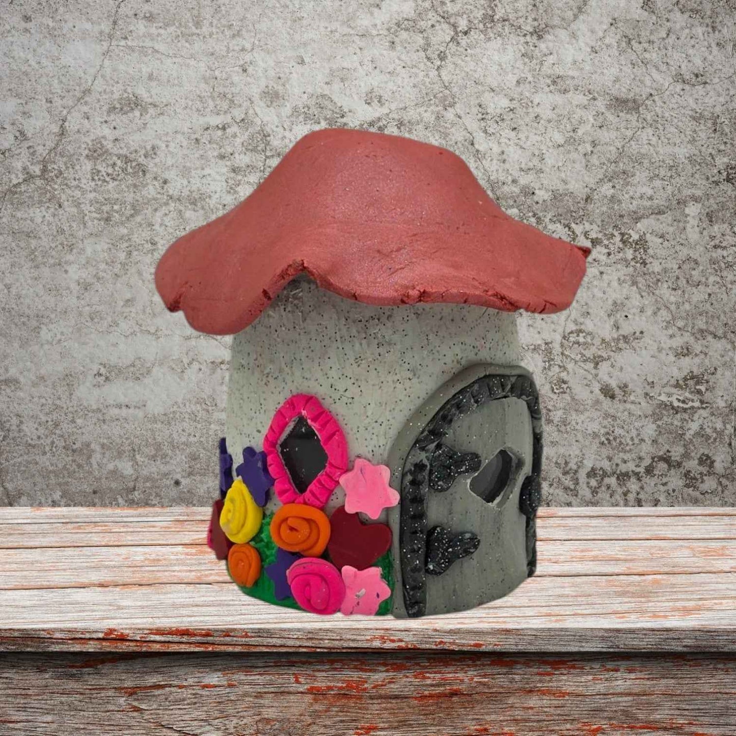 a cottage design fairy house night light with pink roof side view