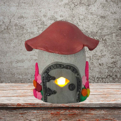 a cottage design fairy house night light with pink roof front view