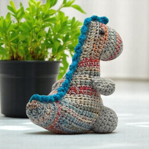 BACK VIEW OF DINOSAUR TOY colored blue red cream