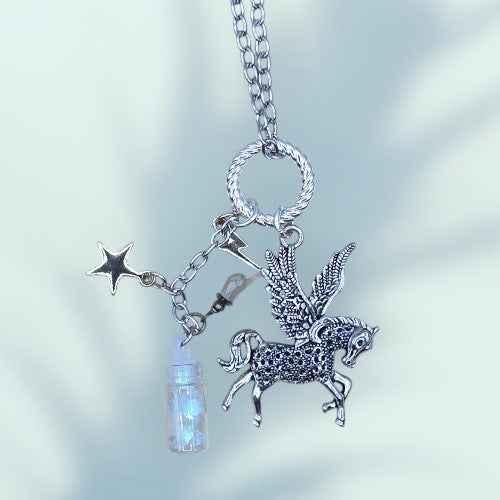 A LONG CHAINE NECKLACE WITH A FLYING HORSE CHARM