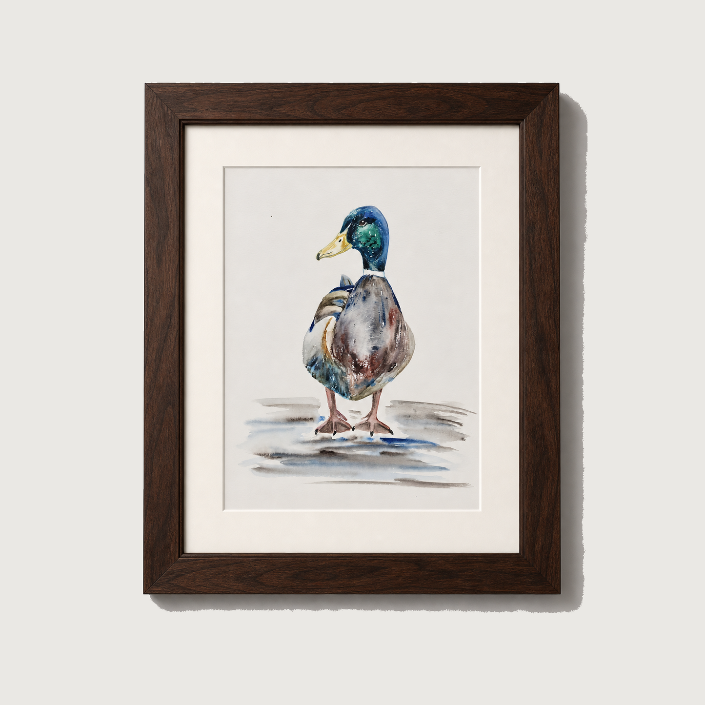 A framed watercolor painting of a mallard duck standing on a light gray background. The artwork features a dark brown wooden frame and a white mat border.