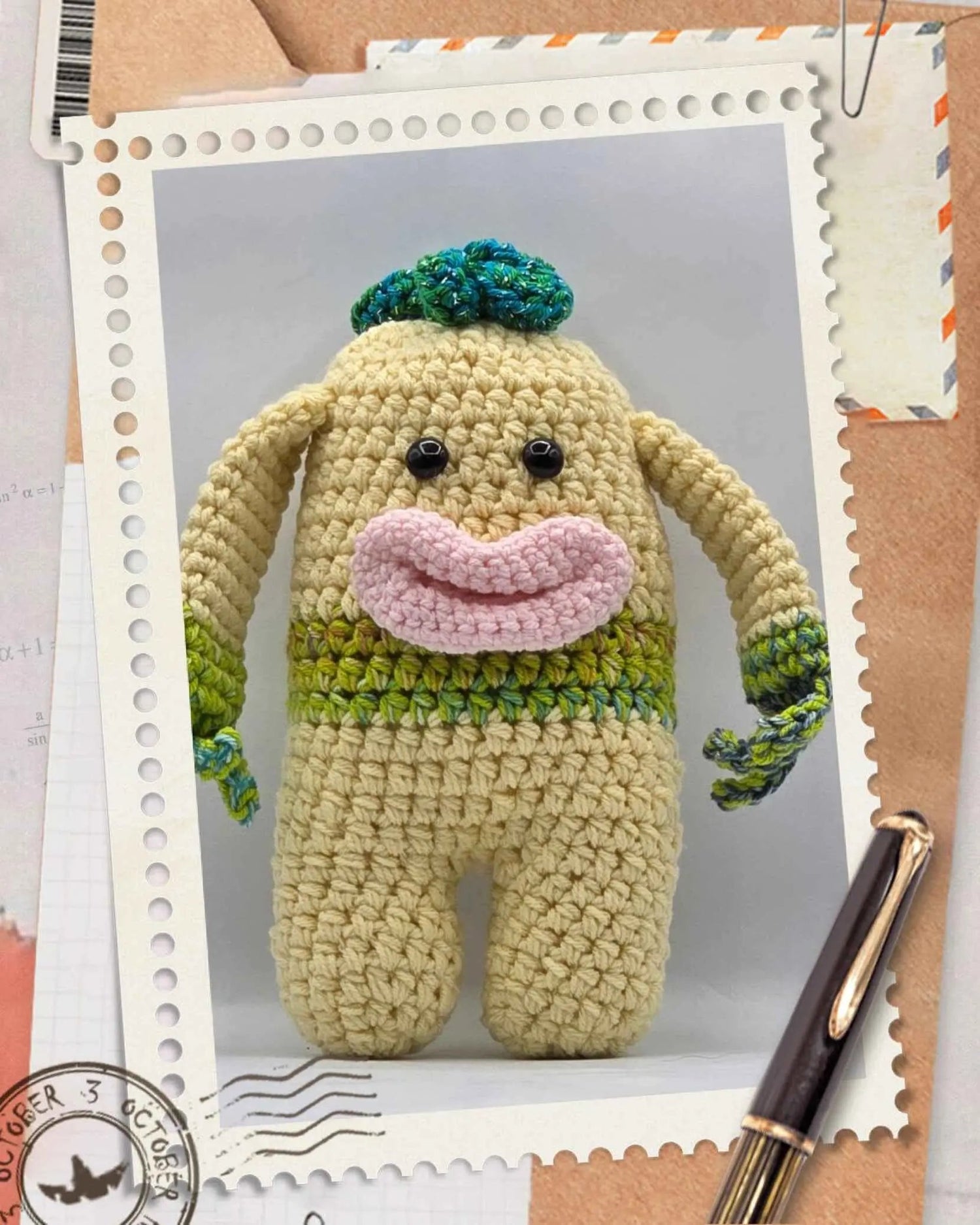 A cheerful green crocheted monster with a wide smile, showcasing its playful and friendly character.