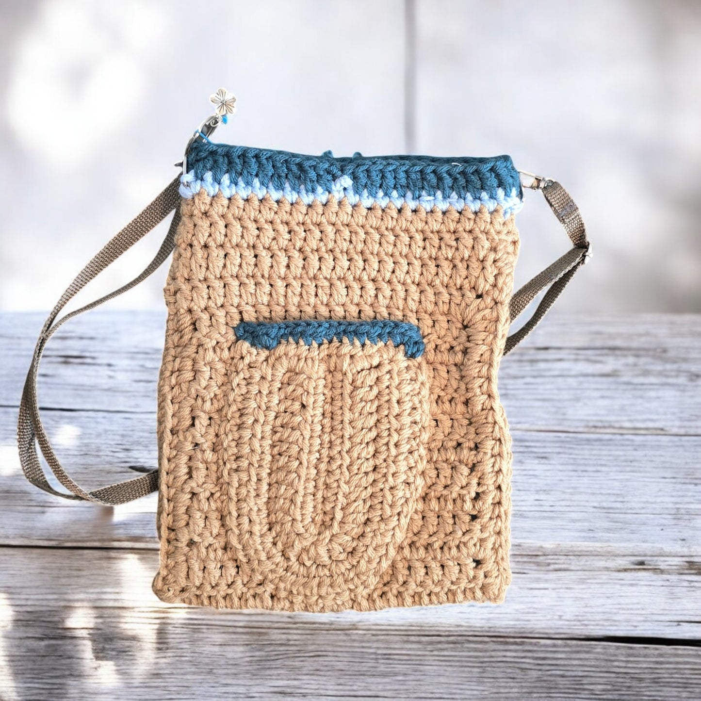 Boho Crochet bag with blue accents on a dark marble background
