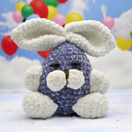 crochet blue bunny with  large white ears and feet facing front