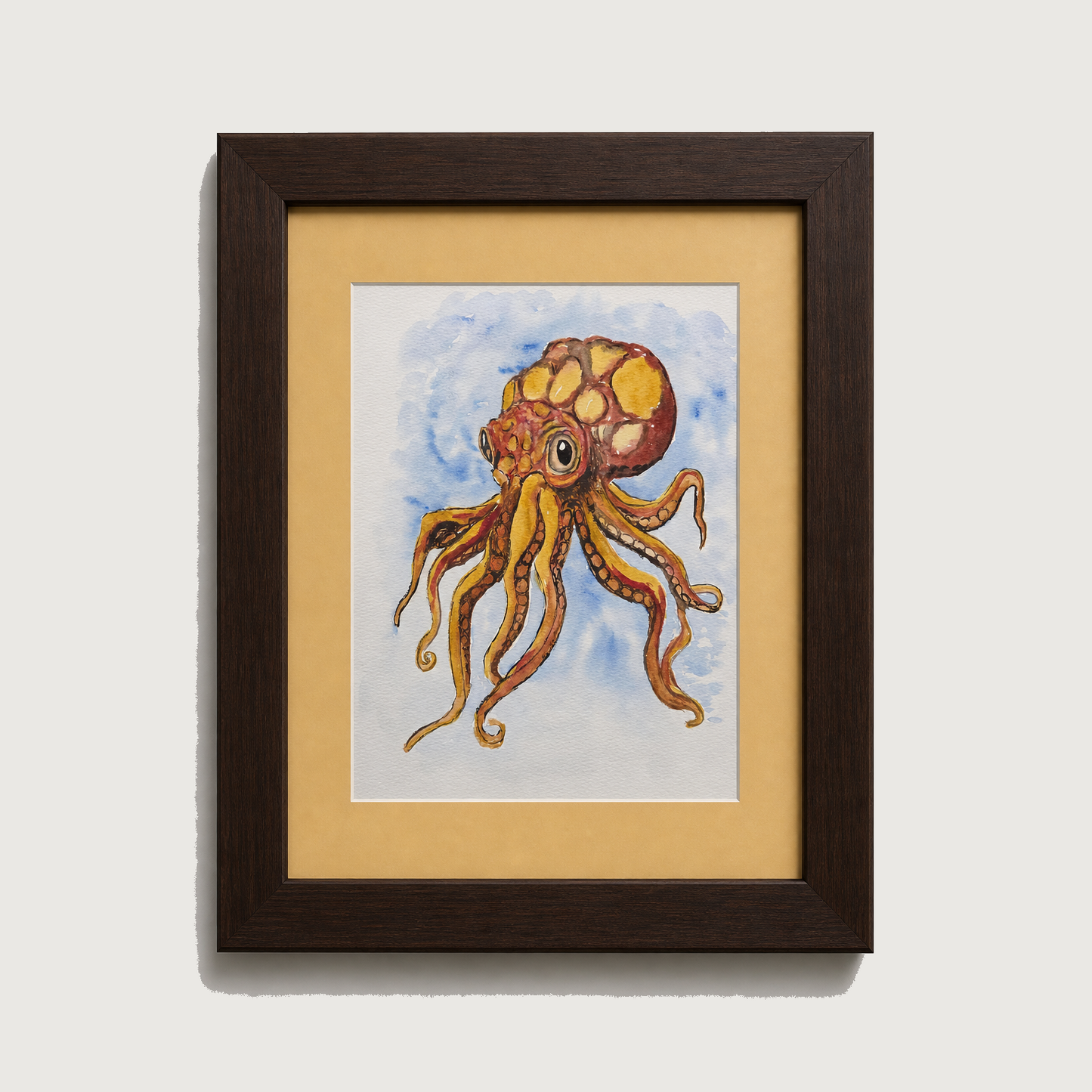 Framed art print featuring a colorful watercolor illustration of an octopus with a patterned shell, set against a light blue water background. The print is matted with a wide beige border and enclosed in a dark brown wooden frame, shown against a neutral light gray background.