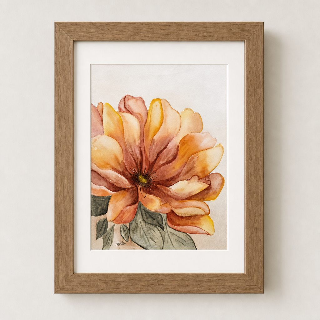 Framed watercolor floral art print featuring a large orange and yellow flower with green leaves, set in a white mat and natural wood frame against a light beige wall.