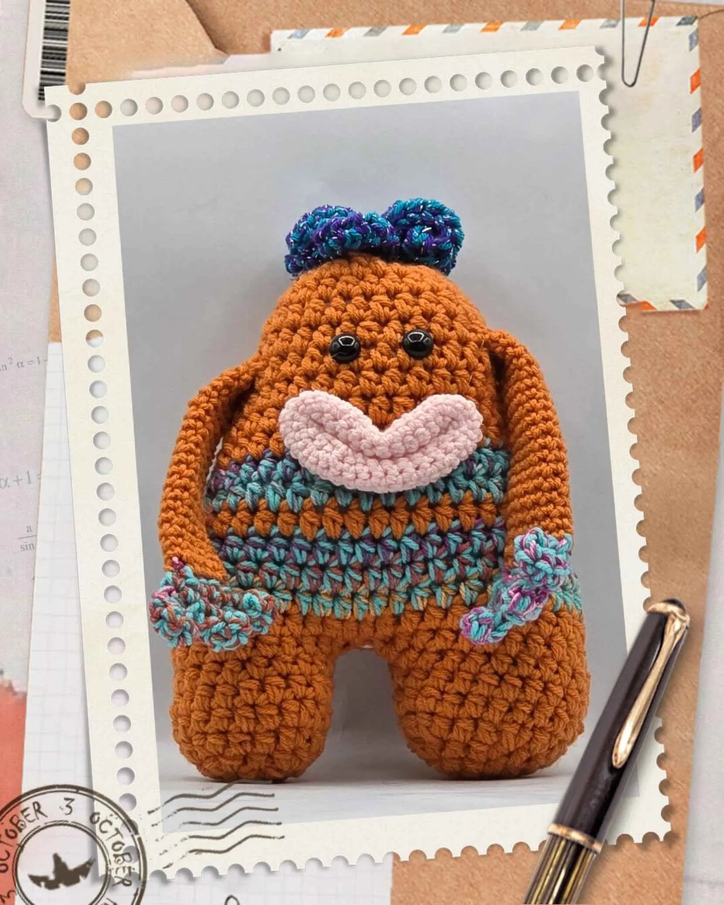A crocheted toy monster of a whimsical orange and blue hair with large eyes and a playful expression.