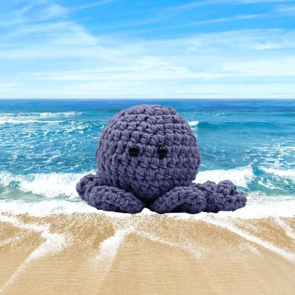 handmade crochet small baby octuput sitting in the ocean color is amehyst