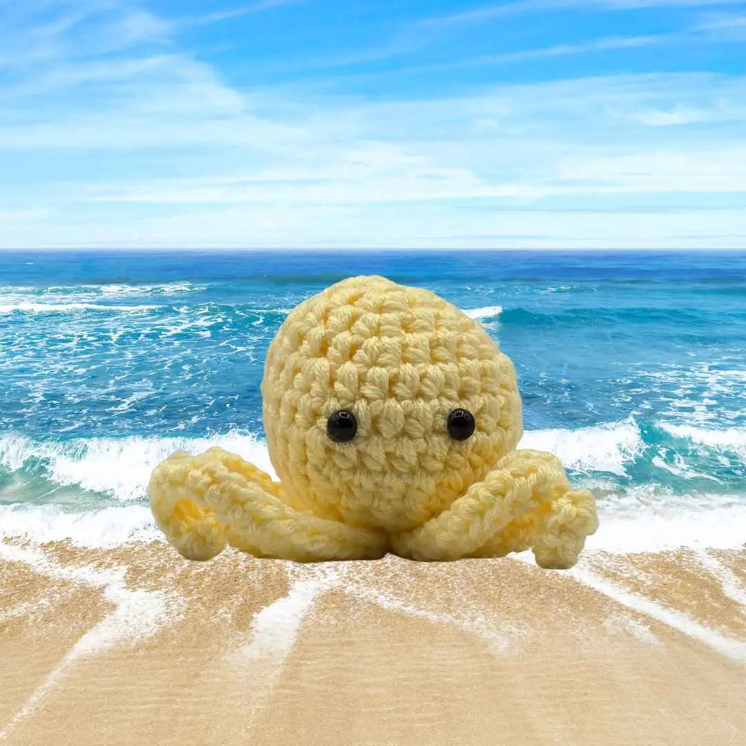 handmade crochet small baby octuput sitting in the ocean color is yellow