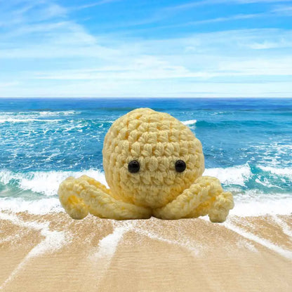 handmade crochet small baby octuput sitting in the ocean color is yellow