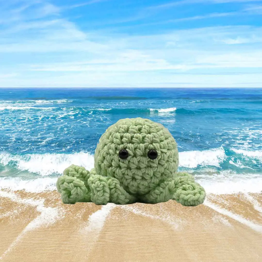 handmade crochet small baby octuput sitting in the ocean color is mynth
