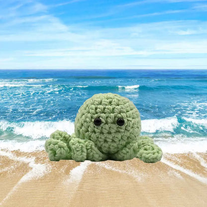 handmade crochet small baby octuput sitting in the ocean color is mynth