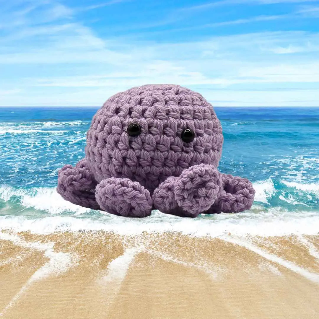 handmade crochet small baby octuput sitting in the ocean color is orchid