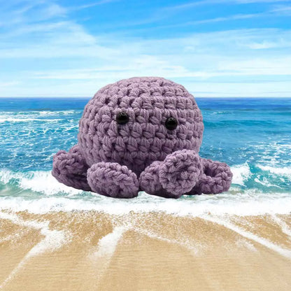 handmade crochet small baby octuput sitting in the ocean color is orchid