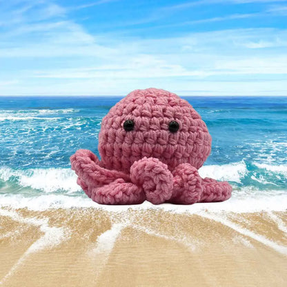 handmade crochet small baby octuput sitting in the ocean color is pink