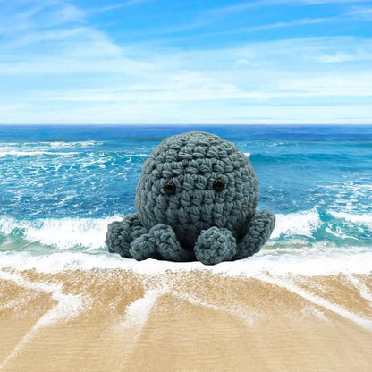 handmade crochet small baby octuput sitting in the ocean color is sea blue