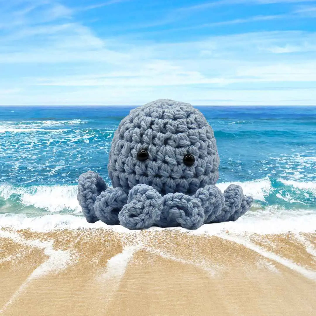 handmade crochet small baby octuput sitting in the ocean color is soft blue