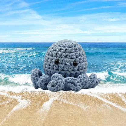 handmade crochet small baby octuput sitting in the ocean color is soft blue