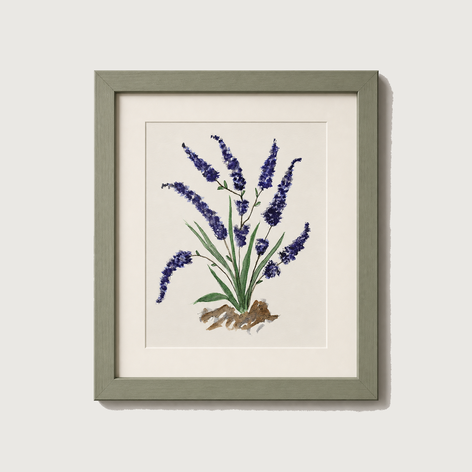 Framed botanical art print of purple lavender flowers with green leaves on a cream background, housed in a muted sage green frame against a light gray wall.