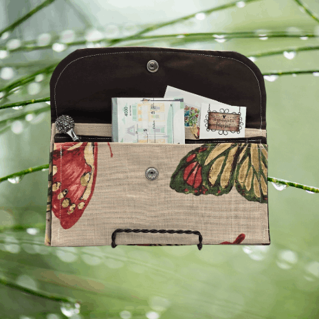 Soft wallet featuring, multiple inside pockets, and a snap closure for secure storage.