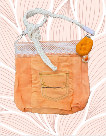 A vibrant tangerine purse featuring a small handmade cactus key fob