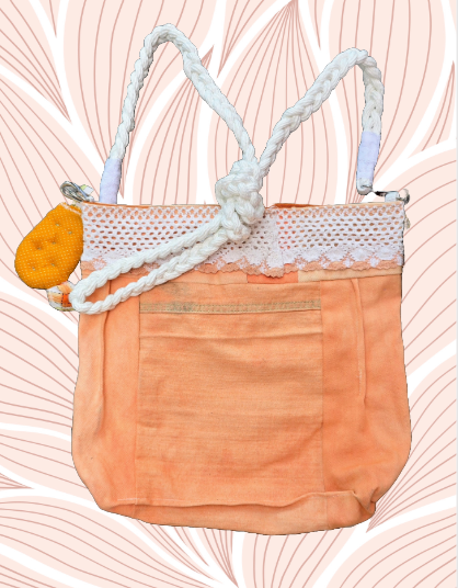 A vibrant tangerine purse featuring a small handmade cactus key fob