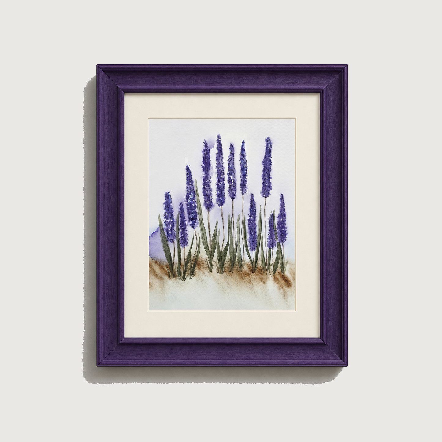 Framed watercolor art print of lavender flowers with a deep purple frame and white mat, shown against a light gray wall.