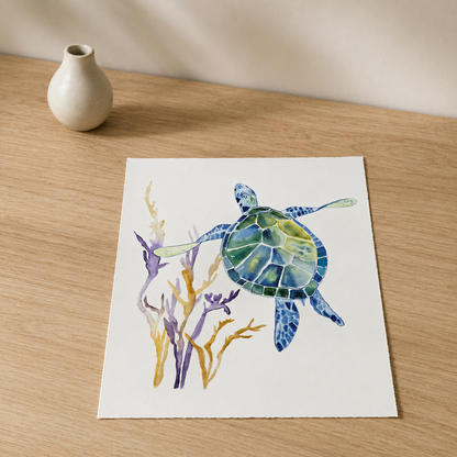 A square art print featuring a watercolor painting of a sea turtle swimming among purple and gold seaweed, displayed on a light wood tabletop next to a small beige ceramic vase.