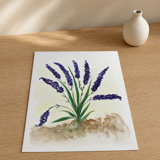 A square art print featuring a watercolor painting of purple lavender flowers with green stems and leaves, displayed on a light wooden table next to a small white ceramic vase.