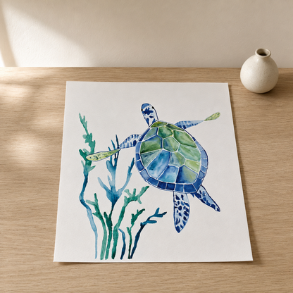 A square art print featuring a watercolor sea turtle and seaweed in shades of blue, green, and navy, displayed on a light wood tabletop next to a small white ceramic vase.
